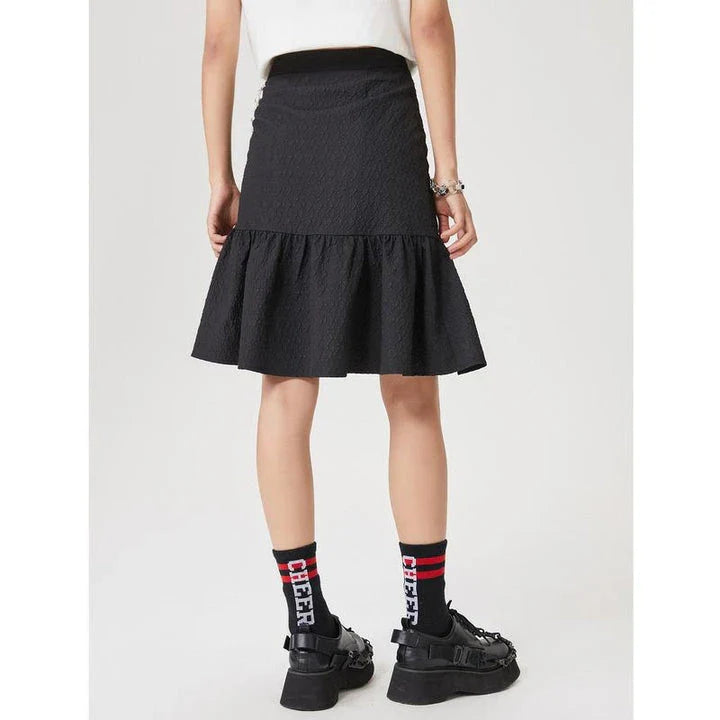 Metersbowne Jacquard Swallowtail Half Skirt Shorts in Black, featuring an embossed fabric design and a flattering silhouette for summer style.