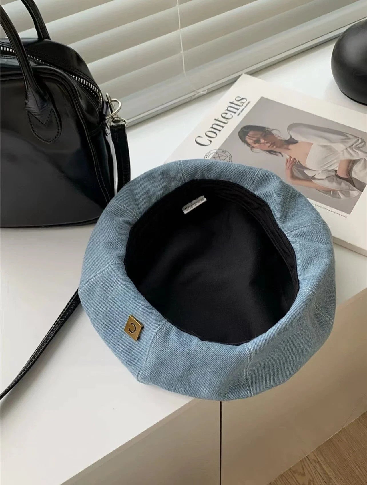 A stylish Japanese-inspired denim beret with a dome-shaped crown and a brimless silhouette, available in light, medium, and dark denim shades.
