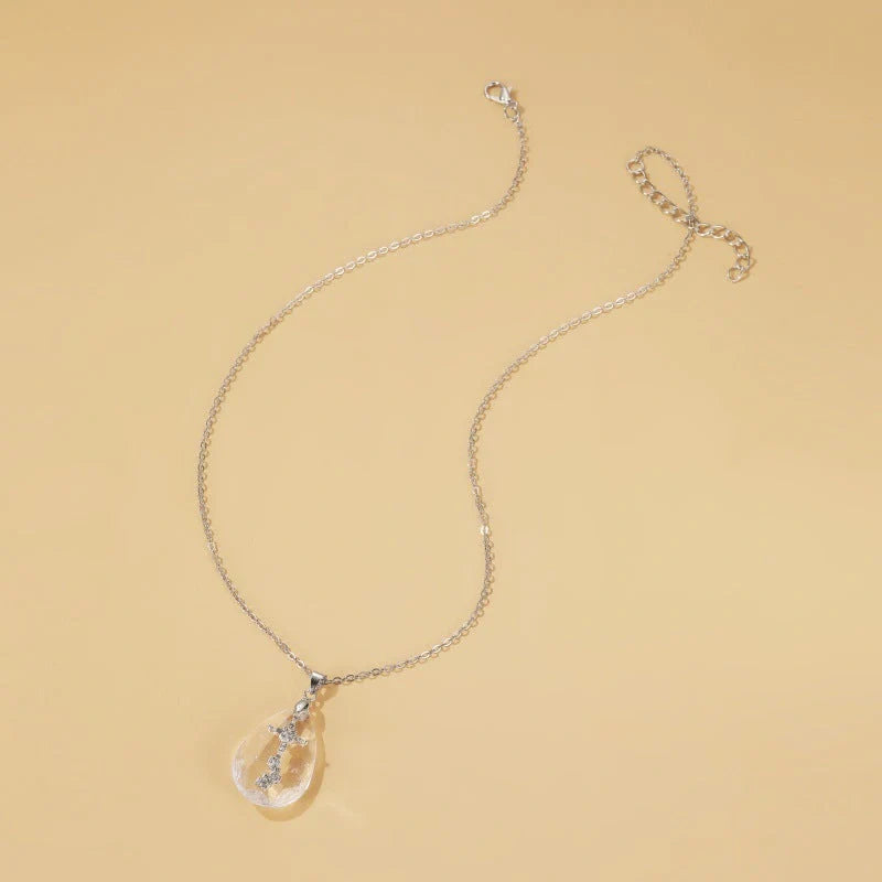 Elegant white drop pendant necklace with cross-chain design, made of premium electroplated alloy for a timeless and sophisticated look.