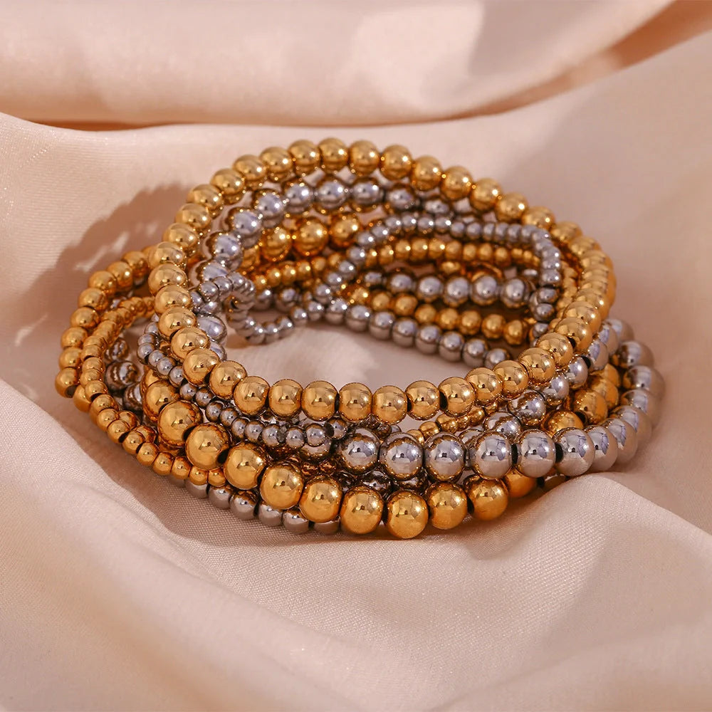 Vintage-inspired stainless steel and 18K plated elastic bead bracelet in a range of sizes and colours