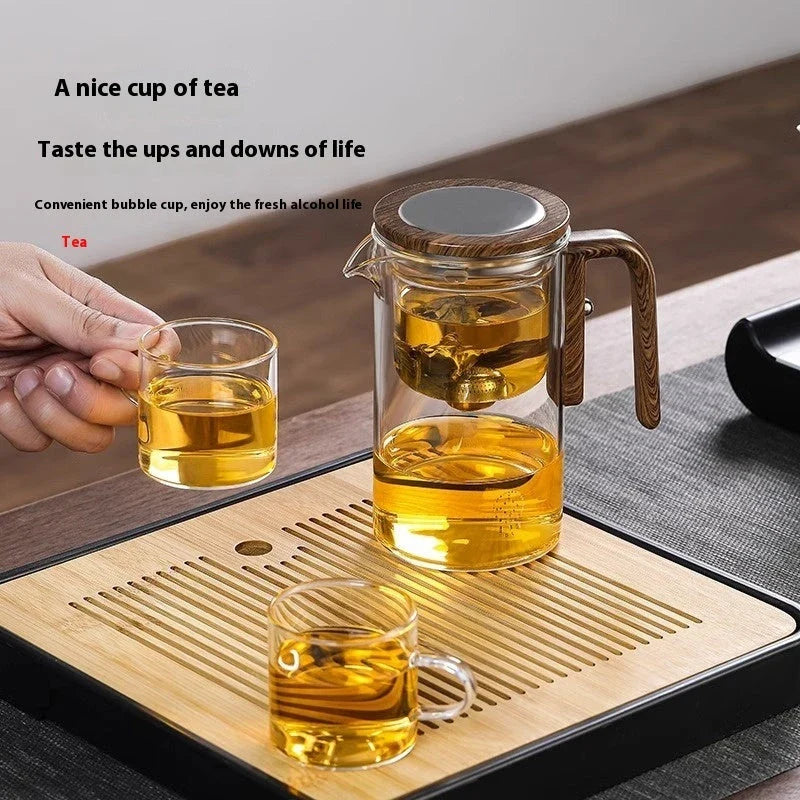 Smart one-button magnetic tea infuser pot with wooden handle, featuring heat-resistant borosilicate glass construction and seamless tea brewing experience.