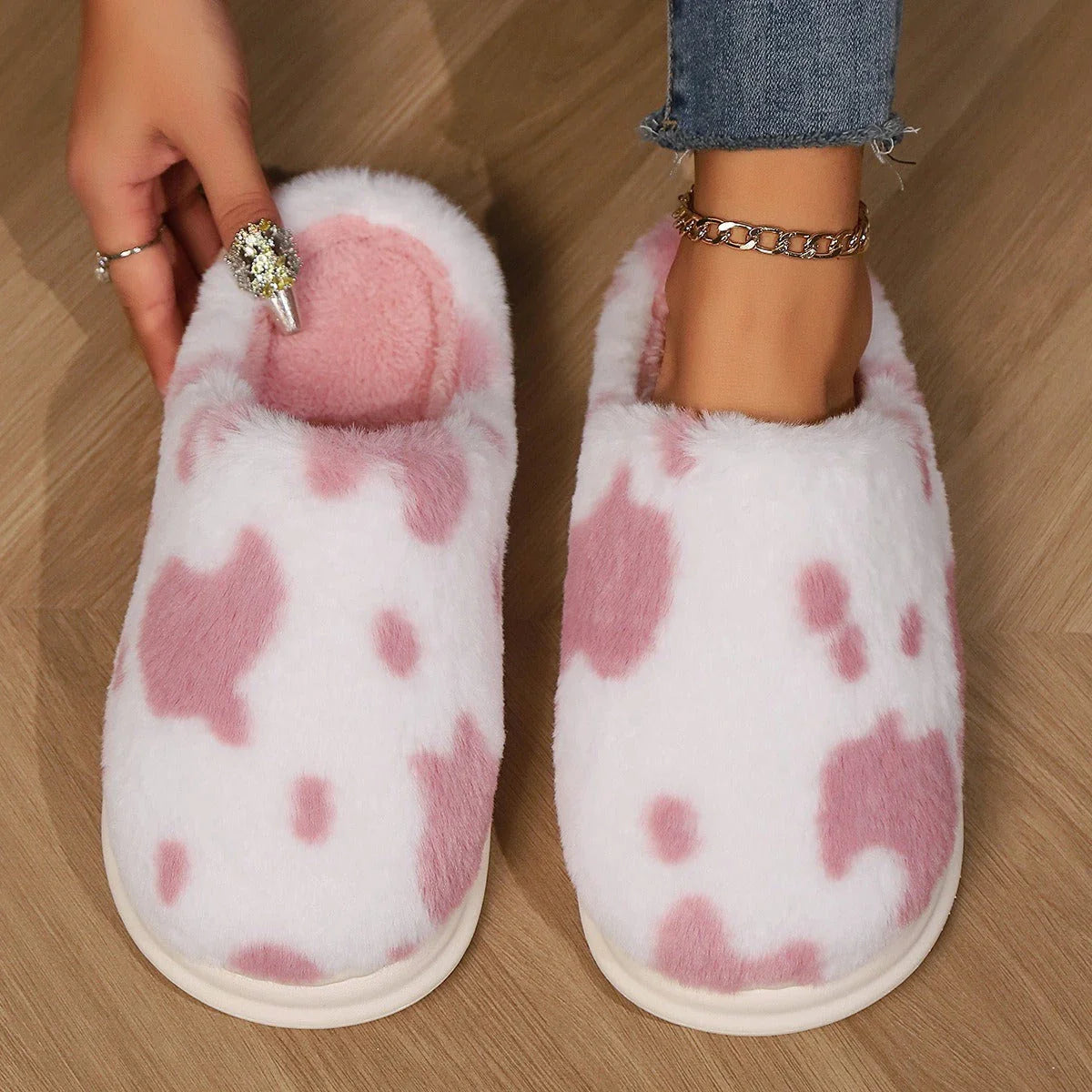 Cozy cow print plush slippers with a non-slip sole, perfect for indoor comfort and warmth