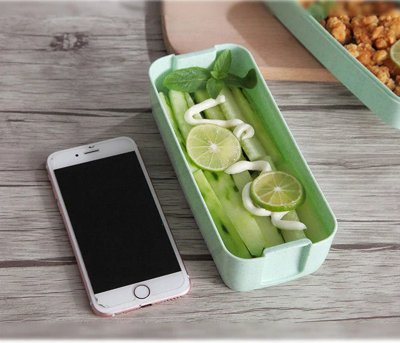 A stylish microwave-safe lunch box with a removable soup mug in various colours, including pink, green, and apricot
