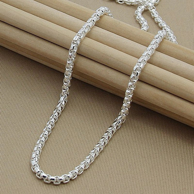 Silver-plated round pendant necklace with secure clasp, showcasing elegant British-inspired design