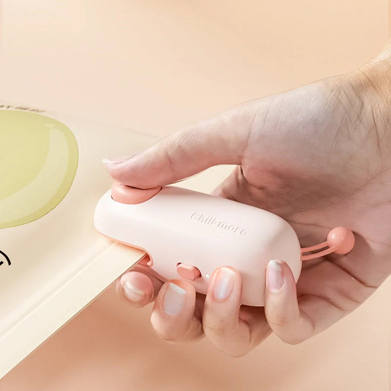 A compact, rechargeable bag sealer with a unique cartoon design, perfect for preserving food freshness at home or on the go.