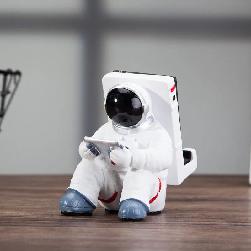 Charming astronaut-themed mobile phone stand made of high-quality resin, designed to securely hold your phone on your desk or workspace