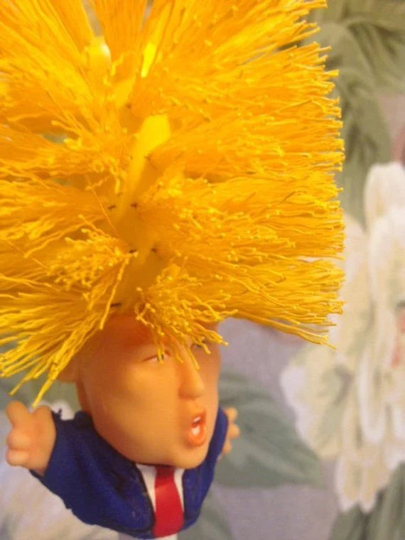 Hilarious Trump-themed toilet brush with bright yellow color and distinctive design