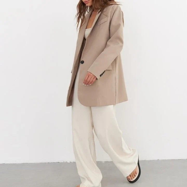 Women's oversized blazer in khaki color, featuring a classic design with a subtle button detail for a sophisticated look.