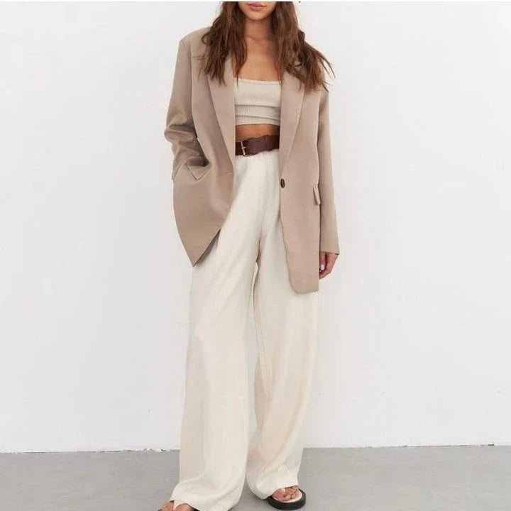 Women's oversized blazer in khaki color, featuring a classic design with a subtle button detail for a sophisticated look.