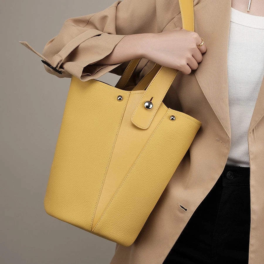 Luxurious genuine leather bucket shoulder bag with adjustable strap and interior pockets, perfect for British women's everyday use
