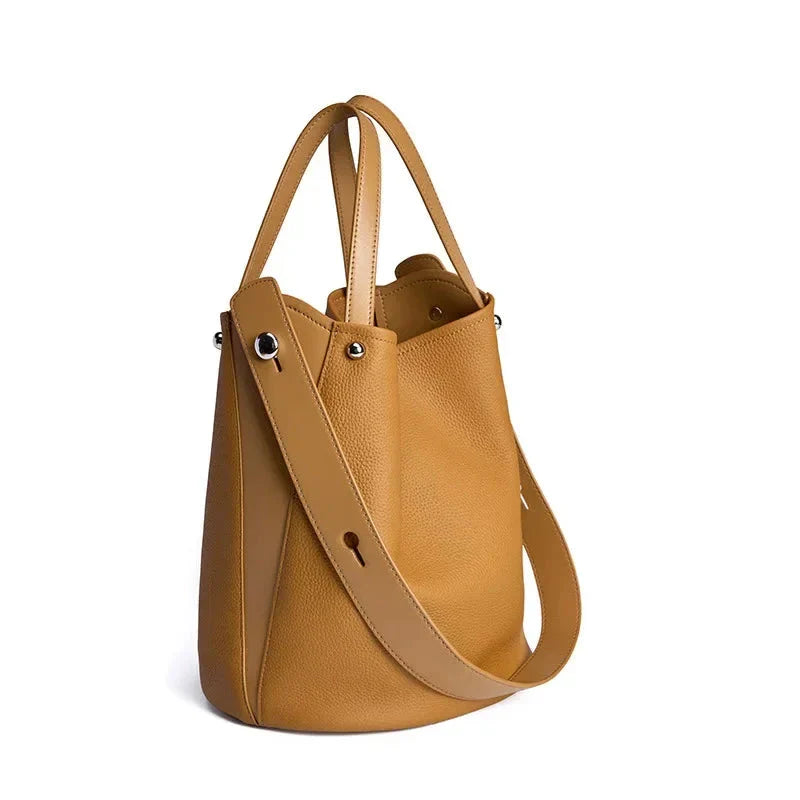 Luxurious genuine leather bucket shoulder bag with adjustable strap and interior pockets, perfect for British women's everyday use