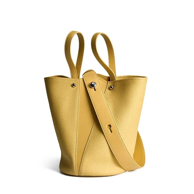 Luxurious genuine leather bucket shoulder bag with adjustable strap and interior pockets, perfect for British women's everyday use