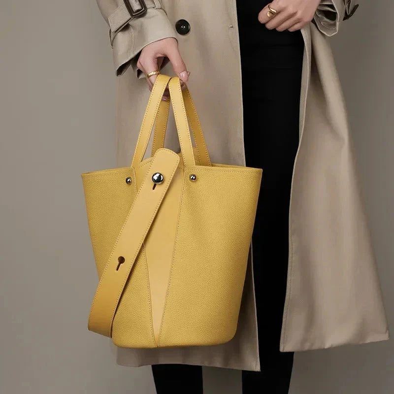Luxurious genuine leather bucket shoulder bag with adjustable strap and interior pockets, perfect for British women's everyday use