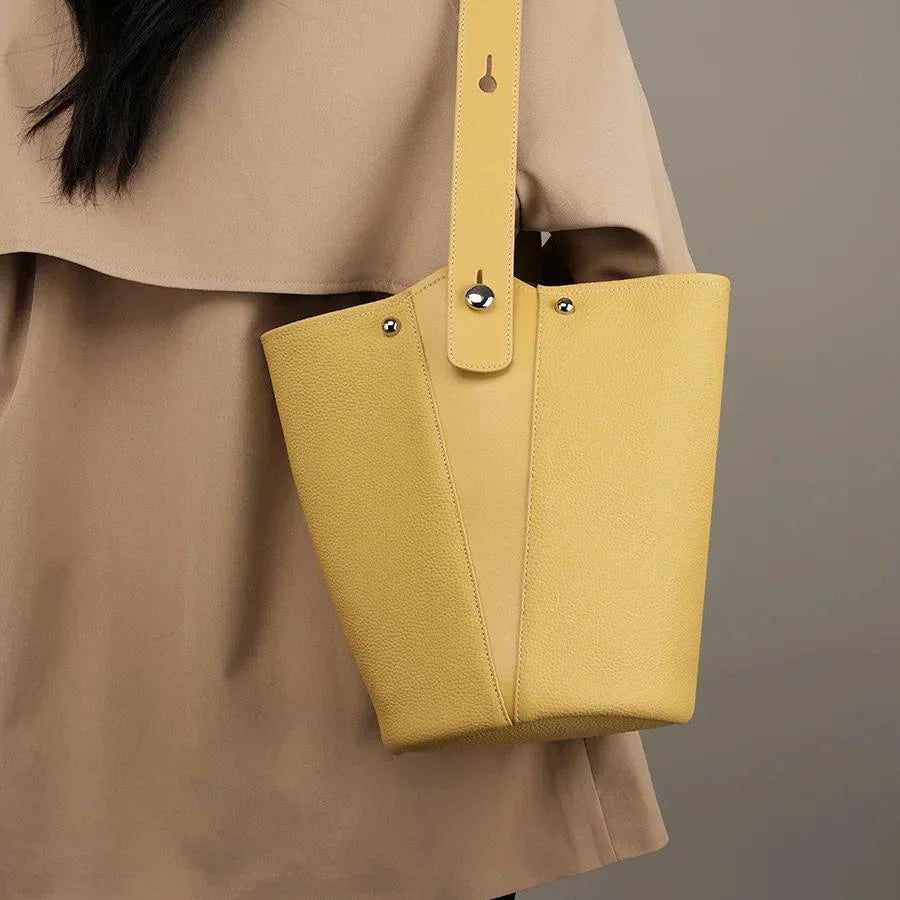 Luxurious genuine leather bucket shoulder bag with adjustable strap and interior pockets, perfect for British women's everyday use