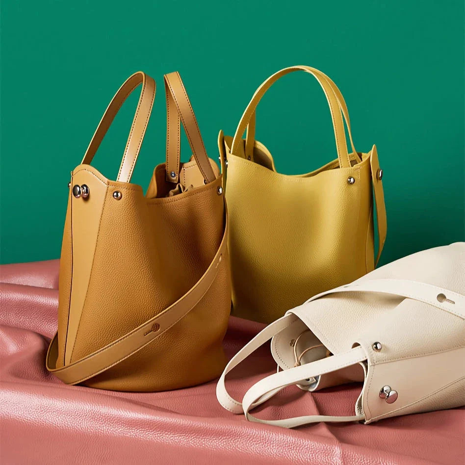 Luxurious genuine leather bucket shoulder bag with adjustable strap and interior pockets, perfect for British women's everyday use