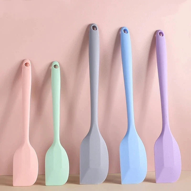 A vibrant red silicone baking spatula with an ergonomic handle and double-sided arc design, perfect for a variety of cooking and baking tasks.