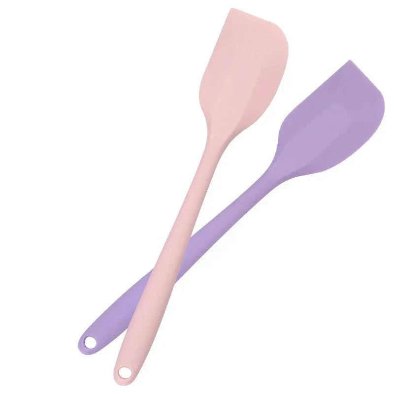 A vibrant red silicone baking spatula with an ergonomic handle and double-sided arc design, perfect for a variety of cooking and baking tasks.