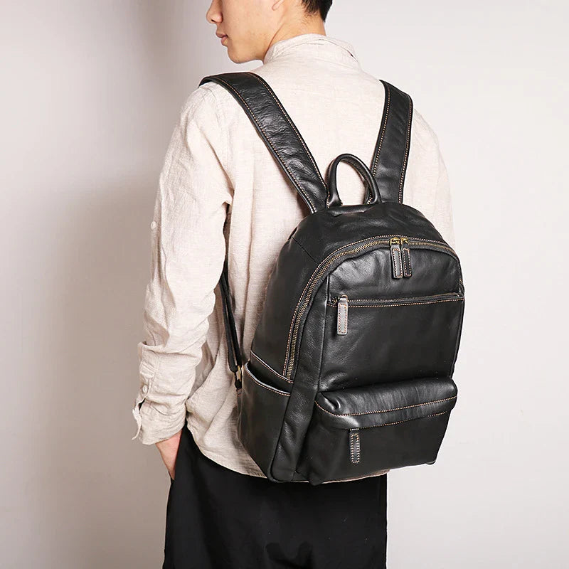 Trendha Men's Leather 14-inch Computer Backpack in Black and Retro Brown colours, featuring a spacious main compartment, laptop sleeve, and multiple pockets for organised storage.