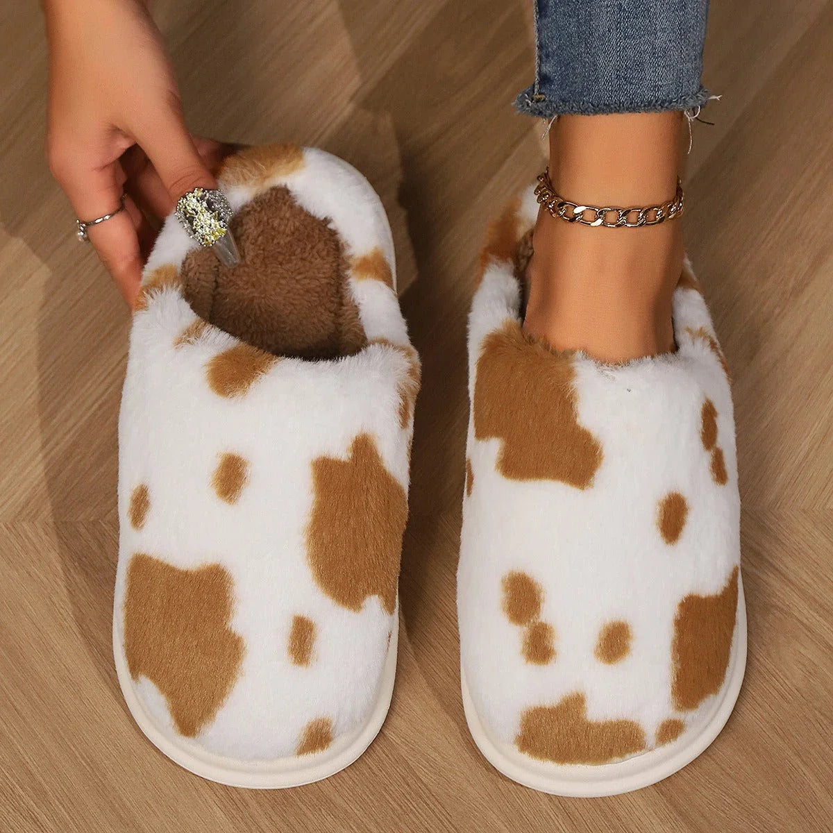 Cozy cow print plush slippers with a non-slip sole, perfect for indoor comfort and warmth
