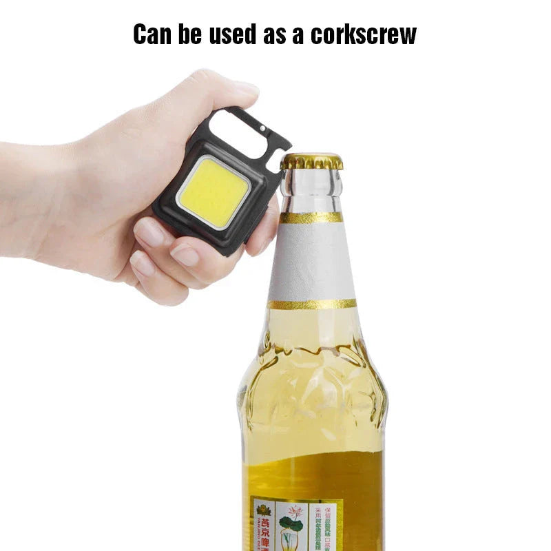 Powerful USB-rechargeable keychain flashlight with three lighting modes, magnetic base, and foldable handle for outdoor and emergency use