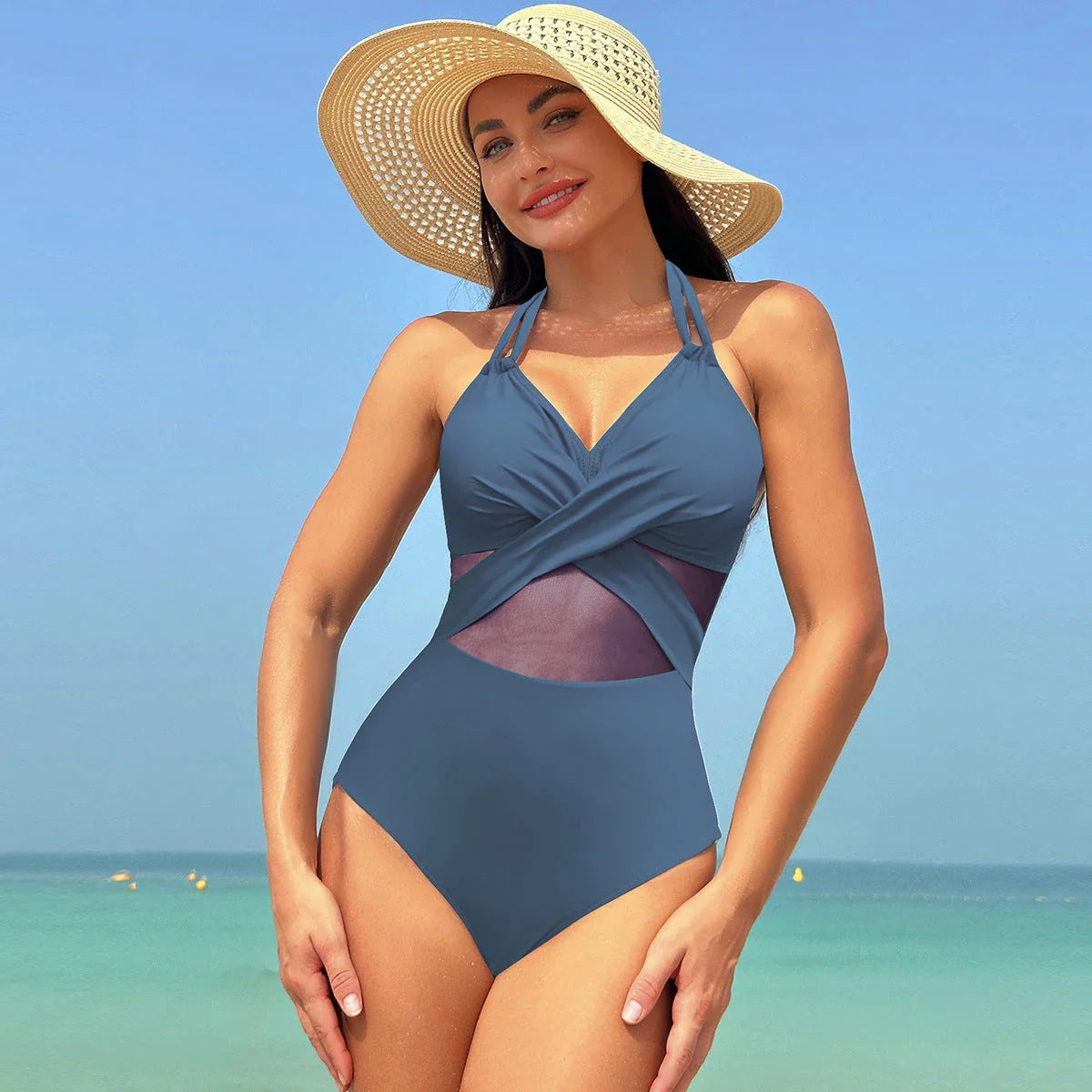 Stylish halter-neck one-piece swimsuit in various colors with cross-strap details and mesh design, perfect for summer beach and vacation wear
