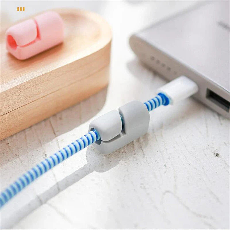 Premium silicone cable clips in various colours for organising and managing cables on desks, entertainment units, and other surfaces