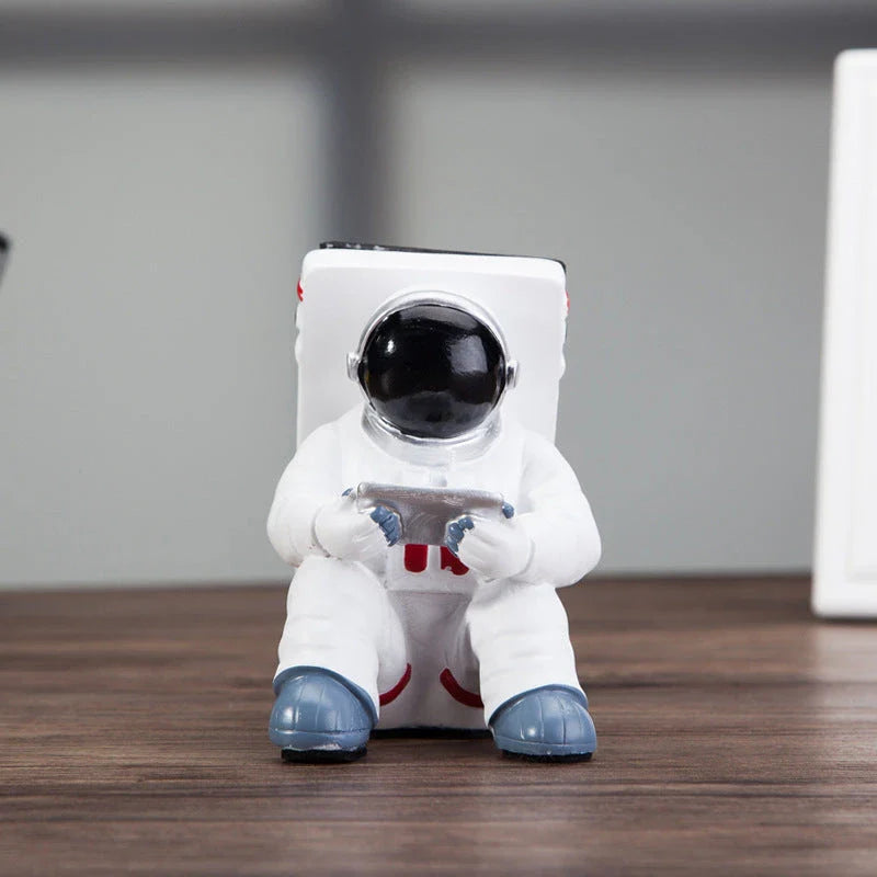 Charming astronaut-themed mobile phone stand made of high-quality resin, designed to securely hold your phone on your desk or workspace
