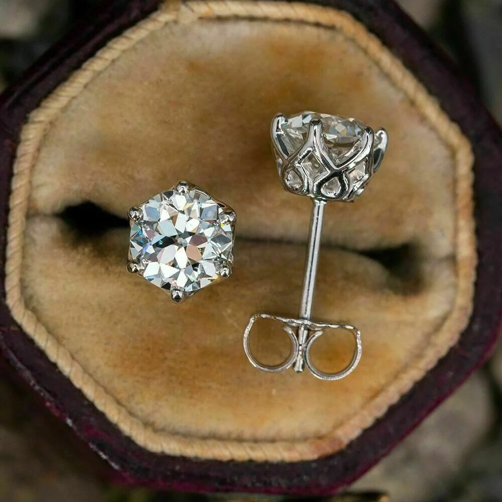 Elegant six-claw diamond zircon ear studs in white gold-toned finish, a fusion of traditional and contemporary style