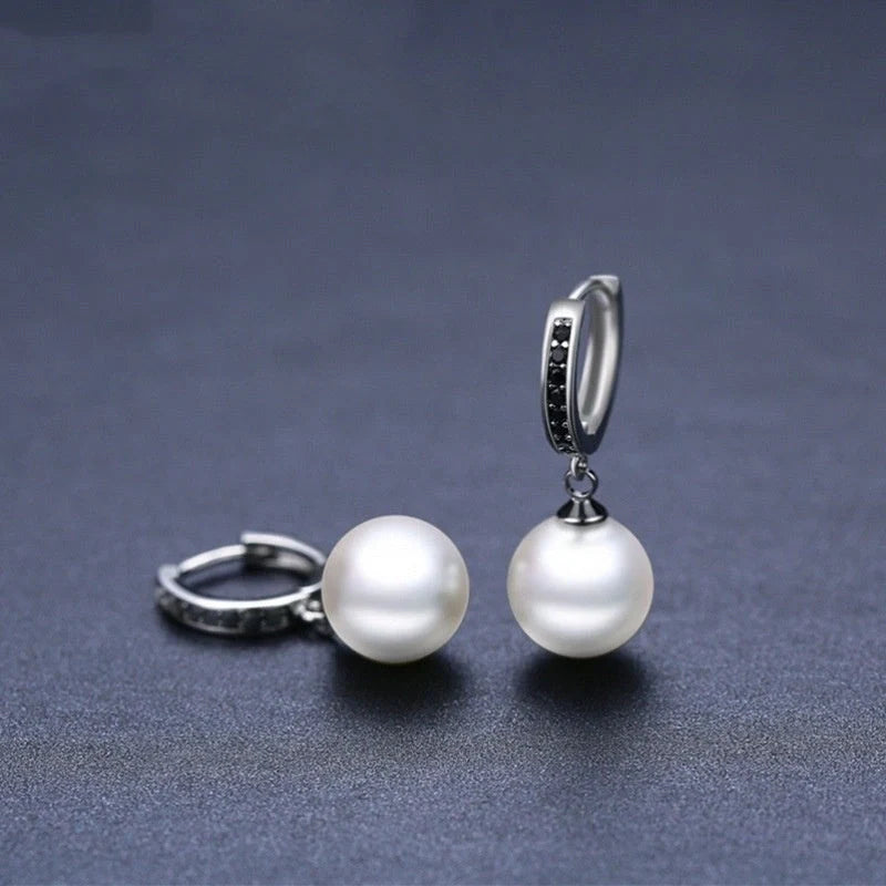 Trendy copper ball stud earrings with a minimalist design, showcasing a sleek and modern accessory for fashion-forward women
