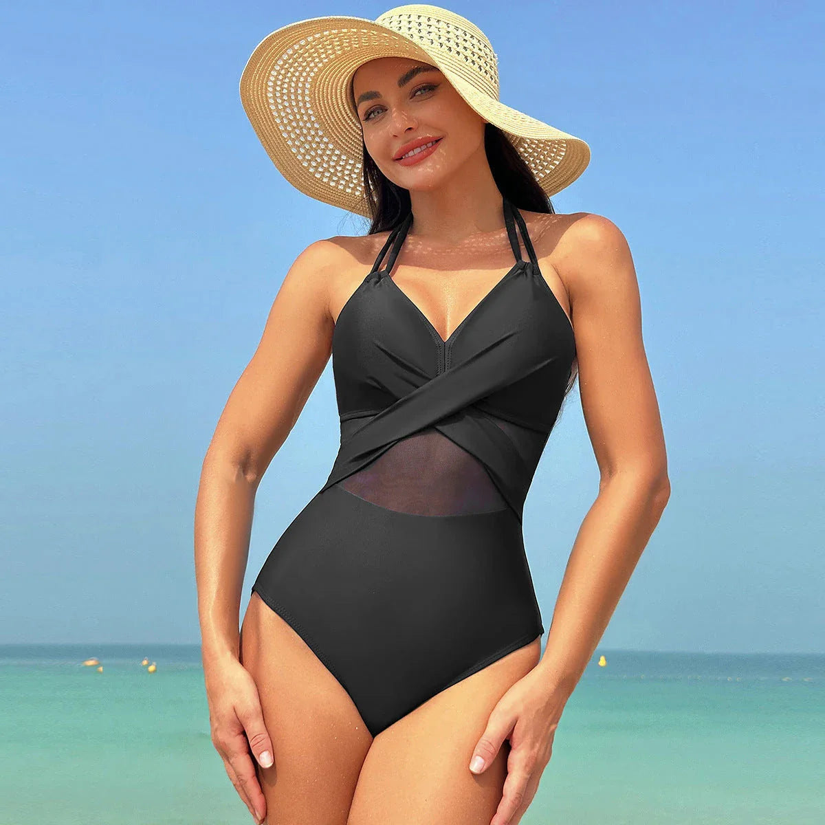 Stylish halter-neck one-piece swimsuit in various colors with cross-strap details and mesh design, perfect for summer beach and vacation wear