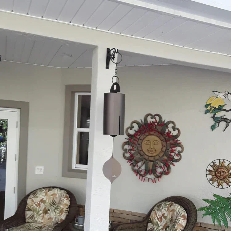 Handcrafted metal wind chimes in black and brown colors, available in small and large sizes, creating a serene outdoor ambiance