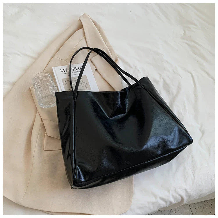 Premium faux leather shoulder bag in various colors, featuring a classic silhouette and roomy interior for everyday convenience.