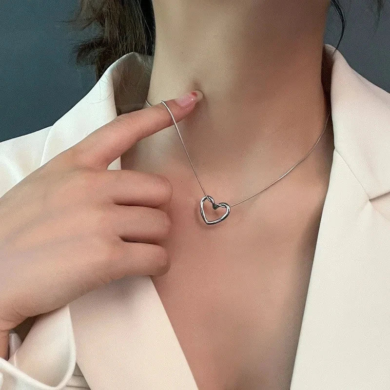 Titanium steel heart pendant necklace in gold and silver finishes, featuring an elegant and adjustable design for a customized fit