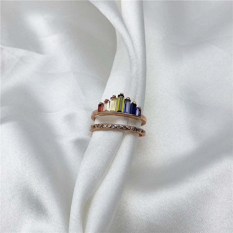Stylish rainbow micro-diamond ring with a geometric design, available in silver and rose gold finishes