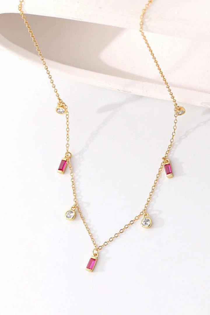 Elegant 18K gold-plated multi-charm chain necklace with delicate charms and a minimalist design