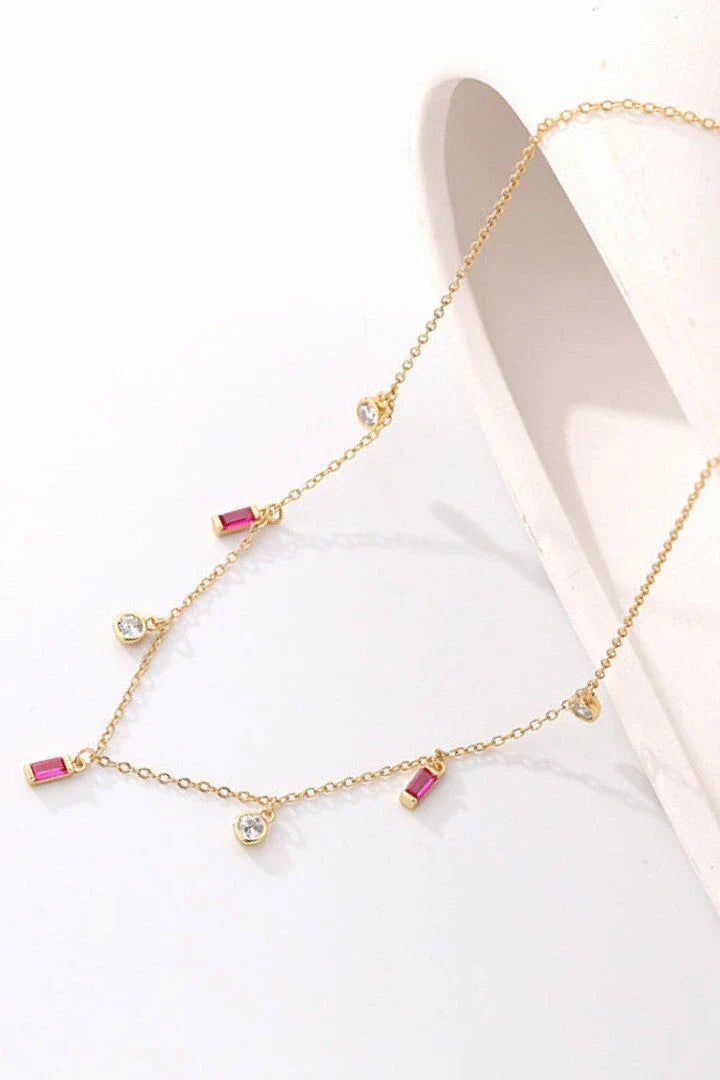 Elegant 18K gold-plated multi-charm chain necklace with delicate charms and a minimalist design