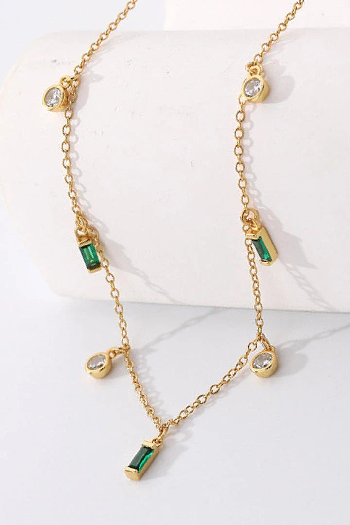 Elegant 18K gold-plated multi-charm chain necklace with delicate charms and a minimalist design
