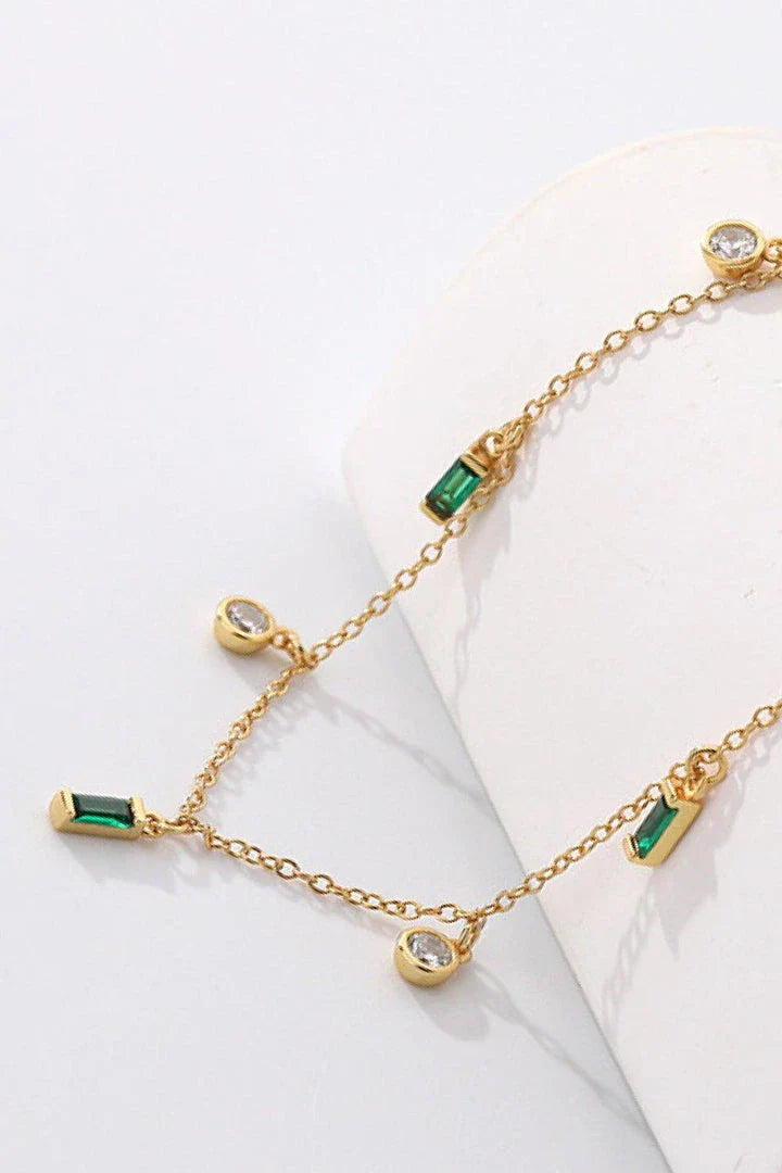 Elegant 18K gold-plated multi-charm chain necklace with delicate charms and a minimalist design