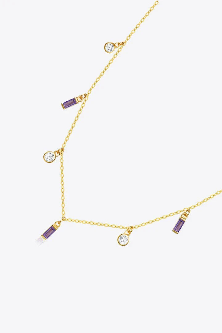 Elegant 18K gold-plated multi-charm chain necklace with delicate charms and a minimalist design