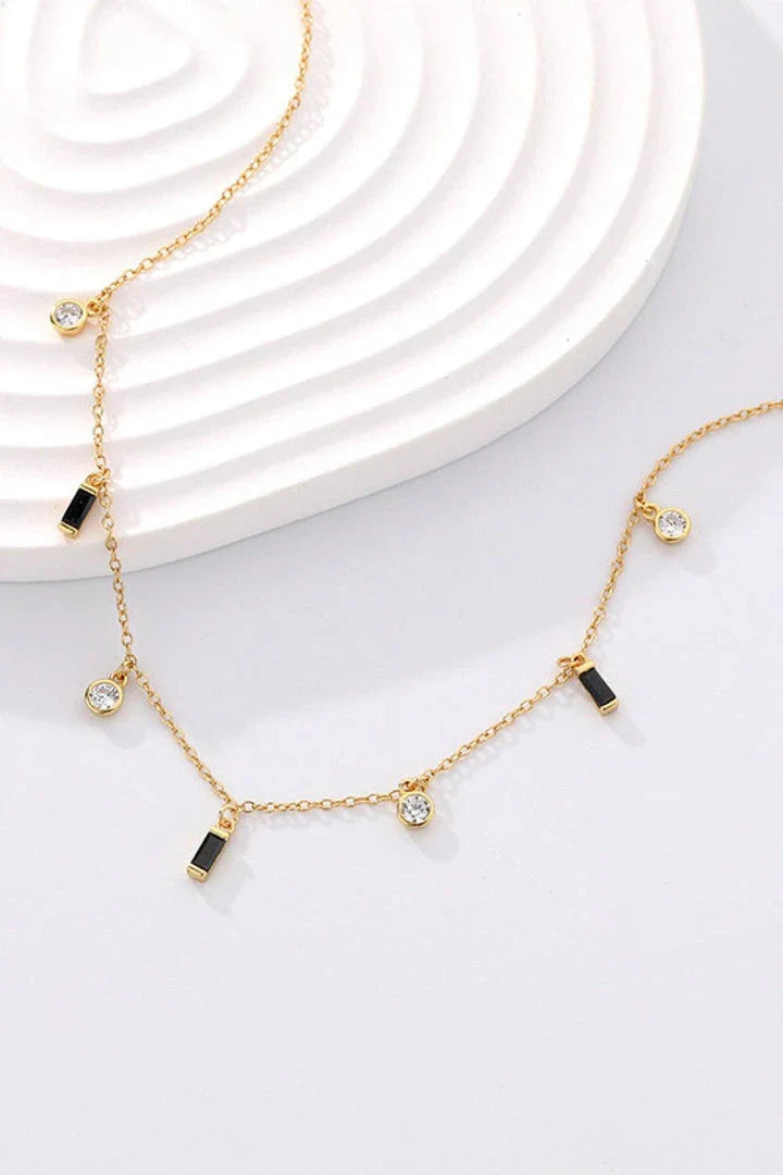 Elegant 18K gold-plated multi-charm chain necklace with delicate charms and a minimalist design