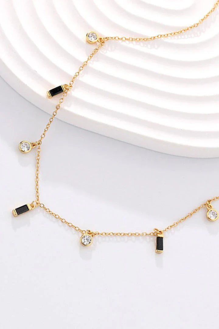 Elegant 18K gold-plated multi-charm chain necklace with delicate charms and a minimalist design