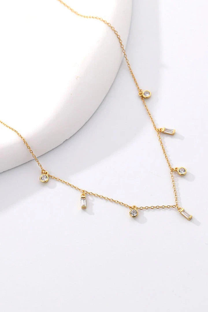 Elegant 18K gold-plated multi-charm chain necklace with delicate charms and a minimalist design