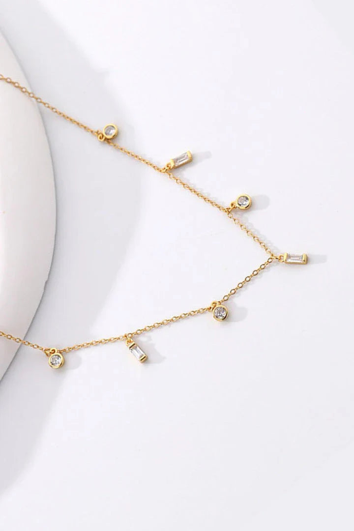 Elegant 18K gold-plated multi-charm chain necklace with delicate charms and a minimalist design