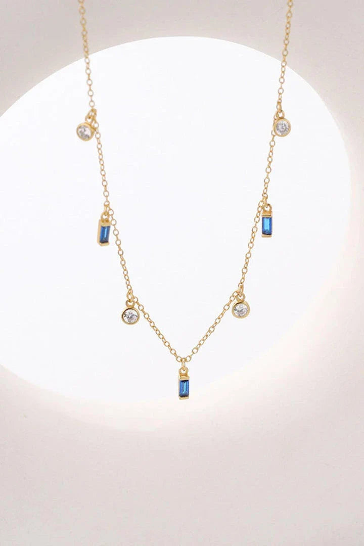 Elegant 18K gold-plated multi-charm chain necklace with delicate charms and a minimalist design
