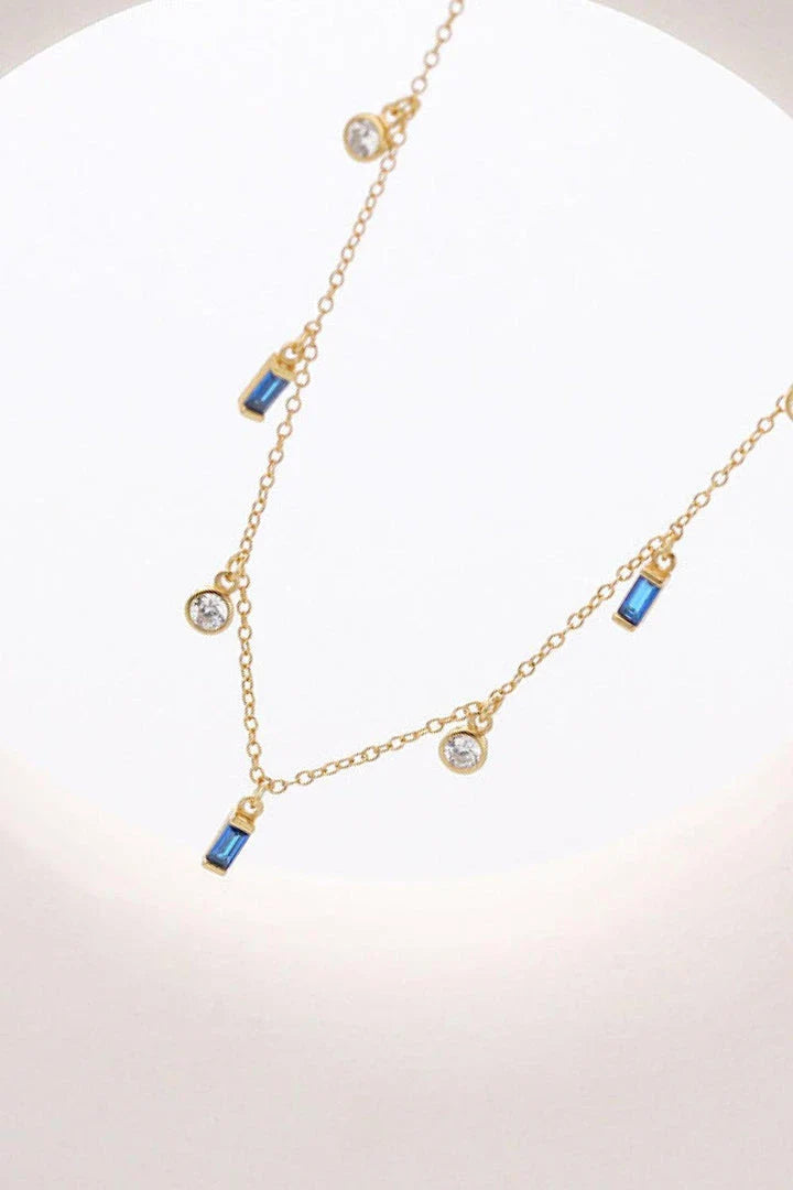 Elegant 18K gold-plated multi-charm chain necklace with delicate charms and a minimalist design