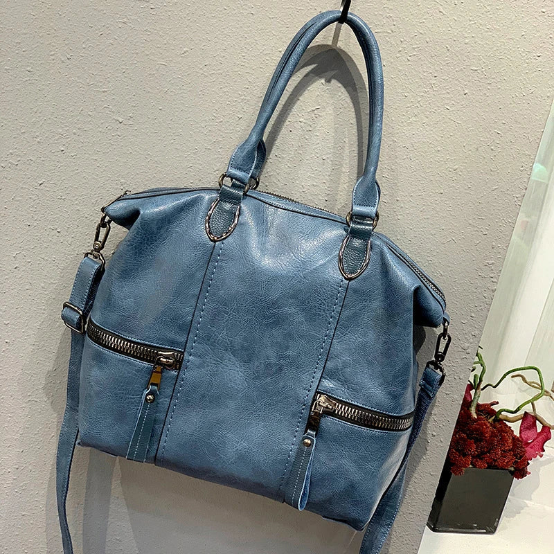 A stylish and spacious leather shoulder messenger bag in a variety of colours, featuring high-quality British craftsmanship