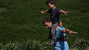 A parent carrying their child hands-free using the Hands-Free Shoulder Carrier, a versatile and comfortable child-carrying accessory.