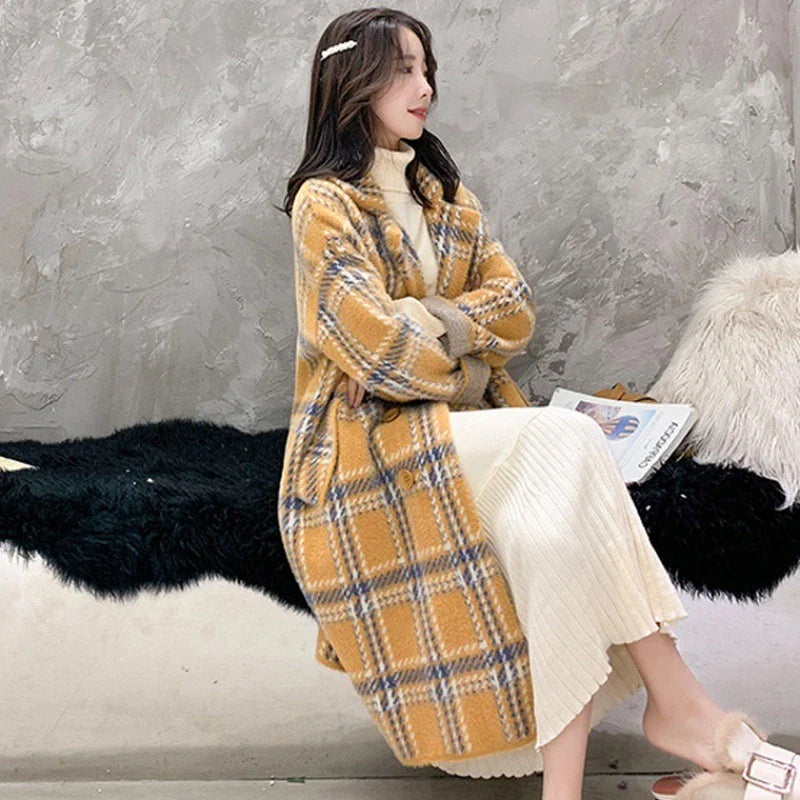 A cosy, thick knitted sweater coat in a classic plaid pattern, featuring a luxurious mink hair blend for superior softness and warmth.