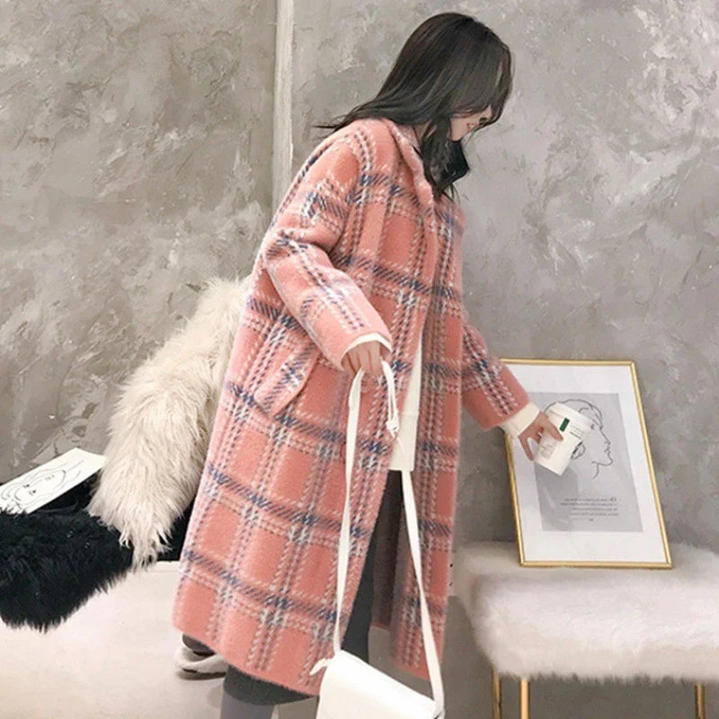 A cosy, thick knitted sweater coat in a classic plaid pattern, featuring a luxurious mink hair blend for superior softness and warmth.