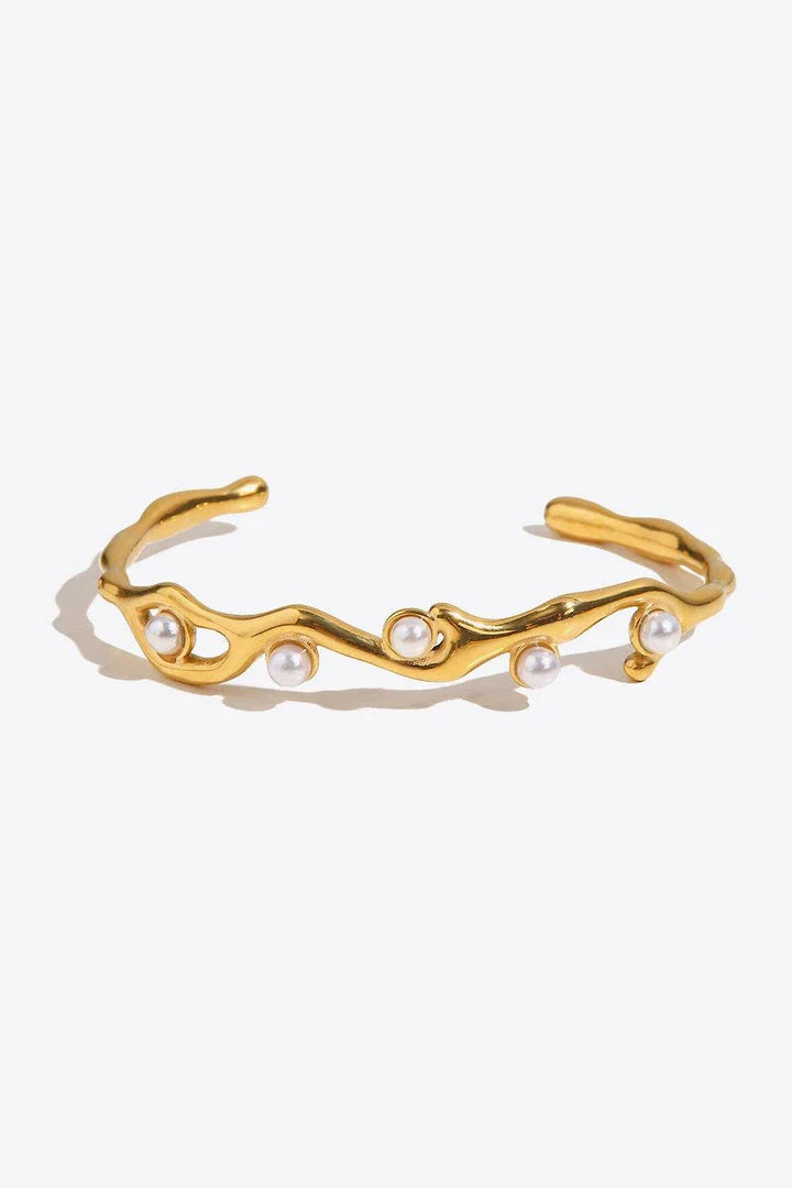 Elegant gold-plated bracelet with synthetic pearl inlays, perfect for enhancing any outfit